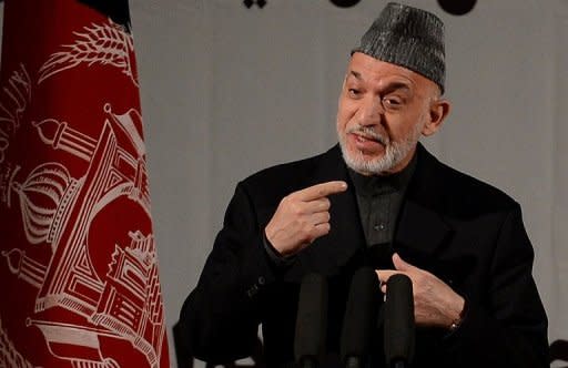 Afghan President Hamid Karzai speaks at a gathering of women to mark International Women's Day, in Kabul on March 10, 2013. In a provocative speech on Sunday, Karzai said the US was in daily talks with the Taliban and that insurgent suicide attacks enabled the international military force to justify its presence in Afghanistan