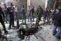 A motorcycle is seen amid residents inspecting a damaged area caused by two explosions in Beirut's southern suburbs, Lebanon November 12, 2015. REUTERS/Hasan Shaaban?