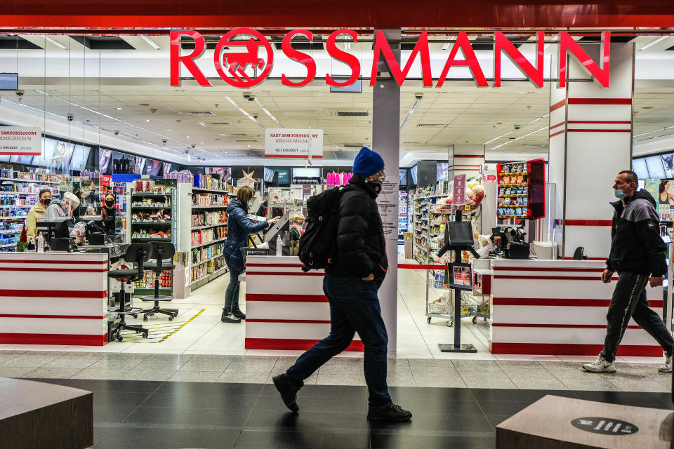 KRAKOW, POLAND - 2020/11/25: People wearing face masks as a precaution against the spread of covid-19, walking past the Rossmann store inside a shopping mall. (Photo by Omar Marques/SOPA Images/LightRocket via Getty Images)