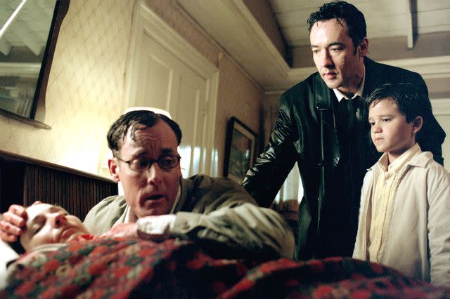 <p>Columbia Pictures/Courtesy Everett Collection</p> From left: Leila Kenzie, John C. McGinley, John Cusack, and Bret Loehr in 'Identity'