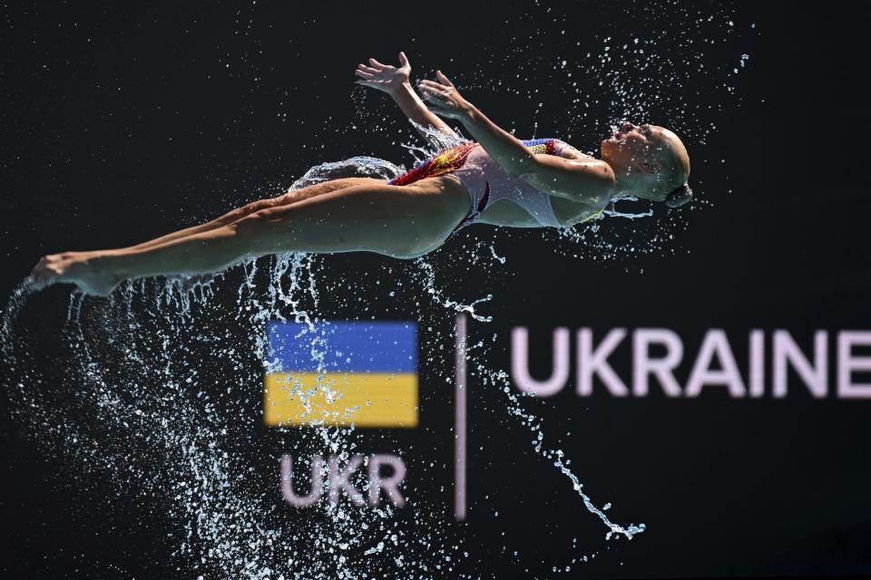 A member of Team Ukraine competes during the final of highlights of the artistic swimming at the 19th FINA World Championships in Budapest, Hungary, Saturday, June 25, 2022. (AP Photo/Anna Szilagyi)