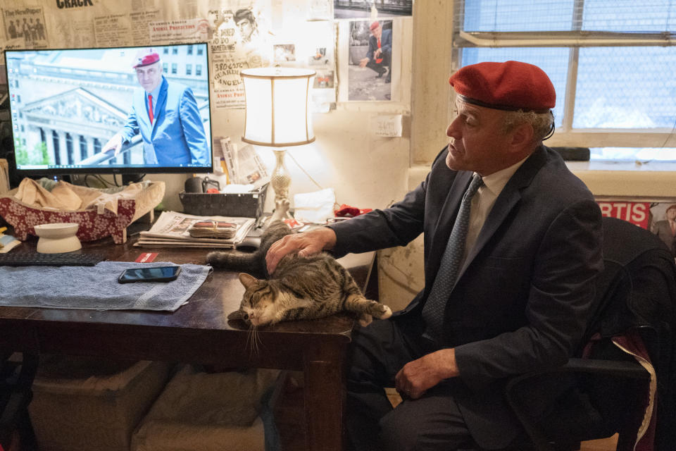 New York City Republican mayoral candidate Curtis Sliwa pets one of his cats as he speaks during an interview with The Associated Press in his apartment, Tuesday, Oct. 12, 2021, in New York. (AP Photo/Mary Altaffer)