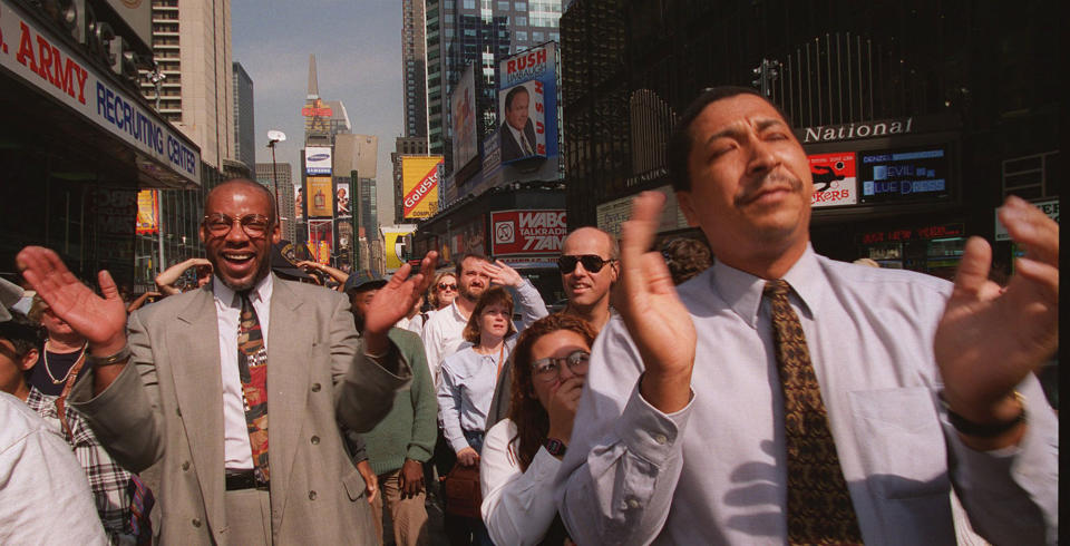 <p>Part of a crowd of pedestrians react as they watch the Jumbotron television screen in New York’s Times Square, Oct. 3, 1995, and the news that O.J. Simpson was found not guilty of killing Nicole Brown Simpson and Ronald Goldman. (Photo: Rosario Esposito/AP) </p>