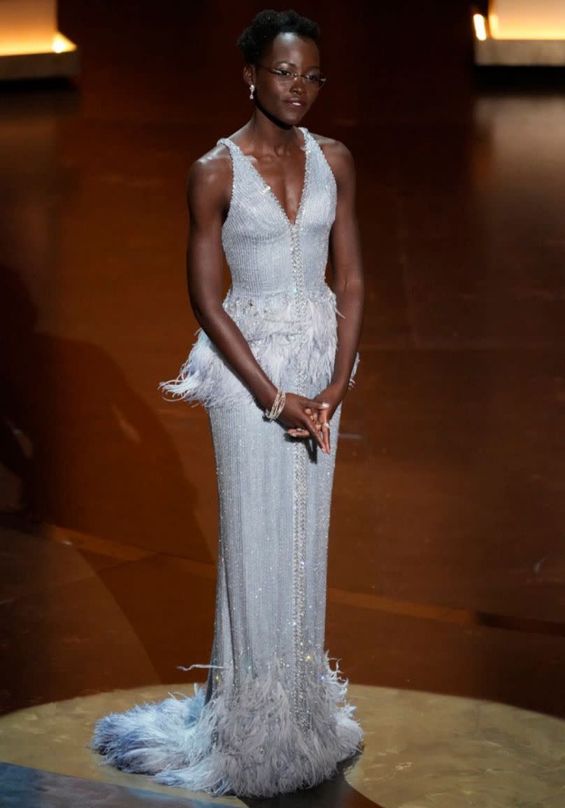 Lupita Nyong'o presents the award for best performance by an actress in a supporting role during the Oscars on Sunday, March 10