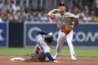 San Diego Padres shortstop Ha-Seong Kim, right, prepares to throw to first to complete a double play after forcing out Atlanta Braves' Freddie Freeman, left, at second base on a ball hit by Ozzie Albies during the first inning of a baseball game Sunday, Sept. 26, 2021, in San Diego. (AP Photo/Derrick Tuskan)