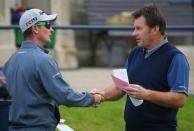 Justin Rose of England (L) shakes the hand of his compatriot Nick Faldo as they stand on the first tee during the second round of the British Open golf championship on the Old Course in St. Andrews, Scotland, July 17, 2015. REUTERS/Eddie Keogh -