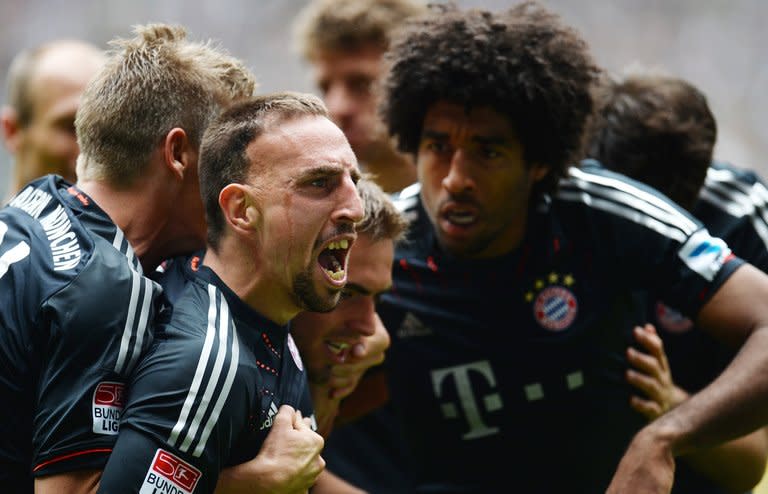 (From L) Bayern Munich's Franck Ribery, Philipp Lahm and Dante celebrate after scoring a goal during a Bundesliga match in M'gladbach, western Germany, on May 18, 2013. The all-German Champions League final between Borussia Dortmund and Bayern on Saturday marks the culmination of an intensifying and increasingly bitter rivalry