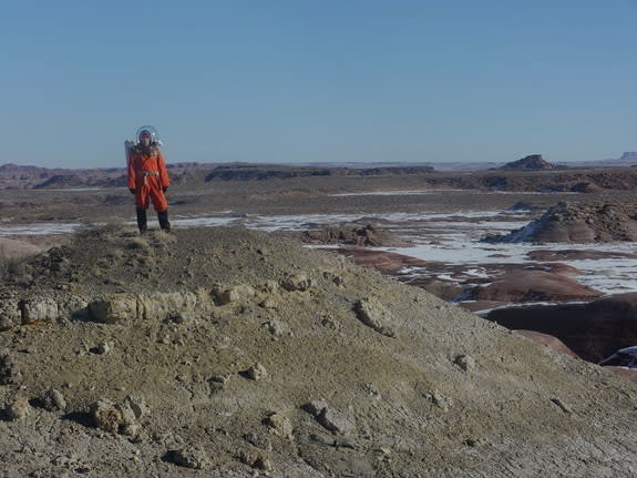 Journalist Elizabeth Howell atop a ridge, wearing a spacesuit, at Utah's Mars Desert Research Station.