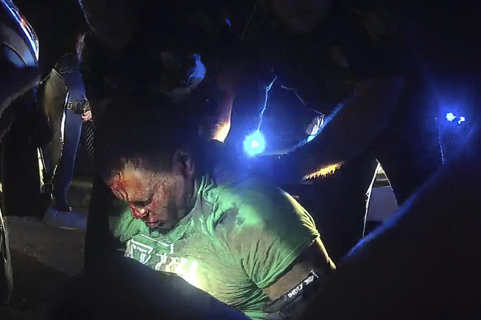 FILE - This image from video from Louisiana state police state trooper Dakota DeMoss' body-worn camera, shows troopers holding up Ronald Greene before paramedics arrived on May 10, 2019, outside of Monroe, La. Text messages obtained by The Associated Press show Louisiana's governor was informed within hours of the deadly 2019 arrest of Ronald Greene. (Louisiana State Police via AP)