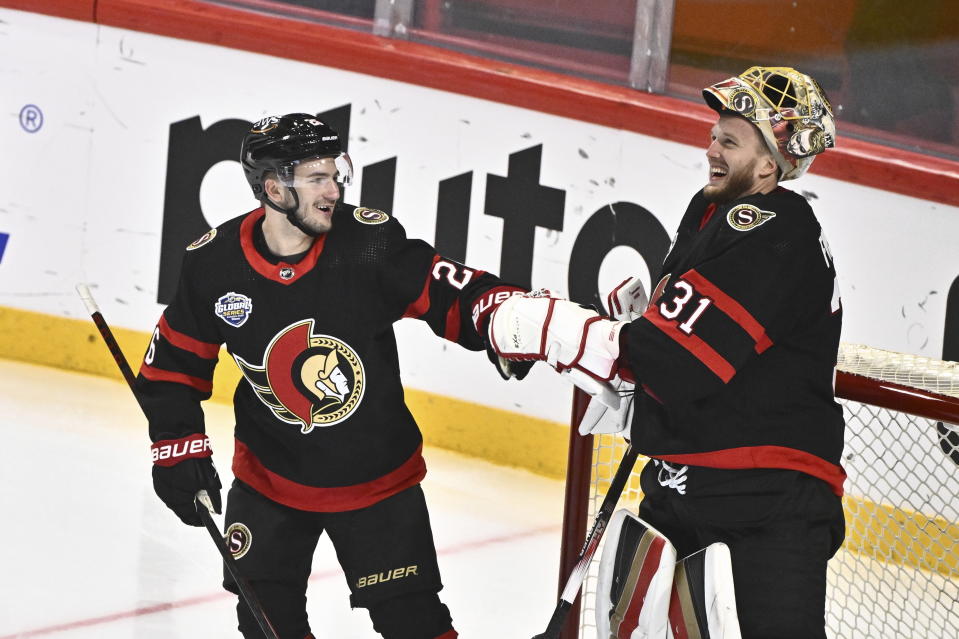 Ottawa's Erik Brannstrom, left, celbrates scoring with goalkeeper Anton Forsberg, right, who assisted during the NHL Global Series Sweden ice hockey match between Minnesota Wild and Ottawa Senators at Avicii Arena in Stockholm, Sweden, Saturday, Nov. 18, 2023. (Claudio Bresciani/TT News Agency via AP)