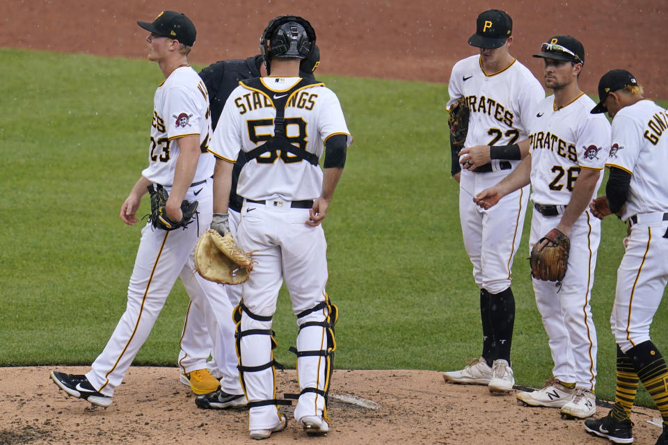 Pittsburgh Pirates starting pitcher Mitch Keller, left, walks off the mound after handing the ball to manager Derek Shelton, rear, during the third inning of a baseball game against the Los Angeles Dodgers in Pittsburgh, Thursday, June 10, 2021. (AP Photo/Gene J. Puskar)