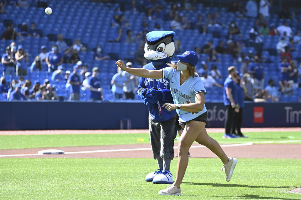 Canadian Olympic gold medalist Kasia Gruchalla-Wesierski throws out the ceremonial first pitch before the start of a baseball game between the Toronto Blue Jays and the Oakland Athletics in Toronto on Saturday, Sept. 4, 2021. (Jon Blacker/The Canadian Press via AP)