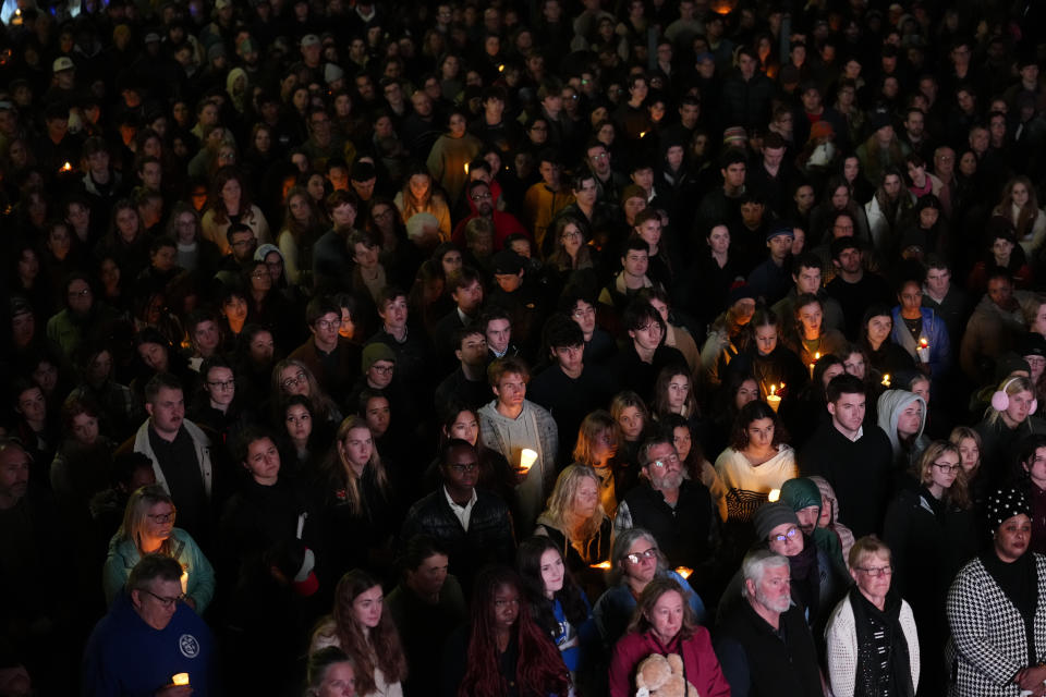 People gather at a vigil for the victims of Wednesday's mass shootings, Sunday, Oct. 29, 2023, outside the Basilica of Saints Peter and Paul in Lewiston, Maine. (AP Photo/Matt Rourke)