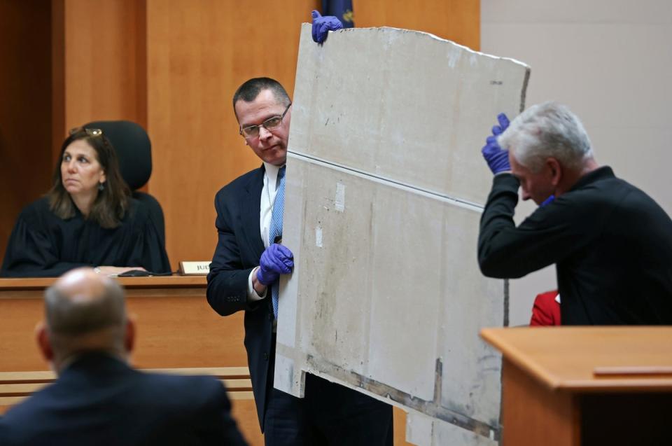 Manchester Police Detective Ray Lamy, left, and Evidence Technician Dave Dydo hold evidence during the trial of Adam Montgomery (AP)