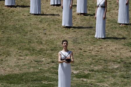 Greek actress Katerina Lehou, playing the role of High Priestess, carries the Olympic flame during the dress rehearsal for the Olympic flame lighting ceremony for the Rio 2016 Olympic Games at the site of ancient Olympia in Greece. REUTERS/Alkis Konstantinidis