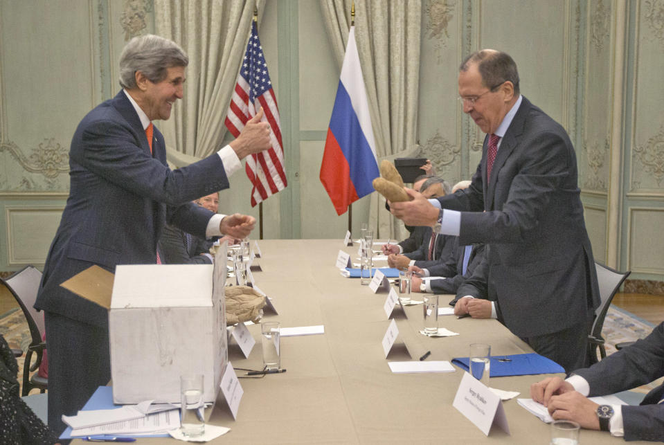 U.S. Secretary of State John Kerry, standing left, gives a "thumbs-up" sign after giving a pair of Idaho potatoes as a gift for Russia's Foreign Minister Sergey Lavrov at the start of their meeting at the U.S. Ambassador's residence in Paris, France, Monday, Jan. 13, 2014. Kerry is in Paris on a two-day meeting on Syria to rally international support for ending the three-year civil war in Syria. (AP Photo/Pablo Martinez Monsivais, Pool)
