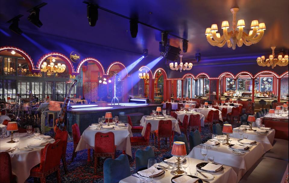 a restaurant with a stage and lights in the middle
