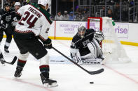 Los Angeles Kings goalie Jonathan Quick (32) defends against Arizona Coyotes forward Hudson Fasching (24) during the first period of an NHL hockey game Sunday, Nov. 21, 2021, in Los Angeles. (AP Photo/Ringo H.W. Chiu)