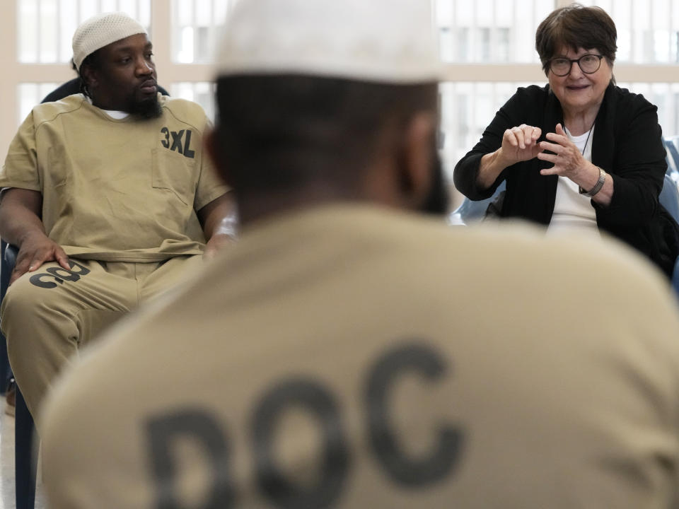 Sister Helen Prejean, right, talks as Richard Obot, left, detainee in Division Of Correction 11, listens to her during a book club at Department Of Corrections Division 11 in Chicago, Monday, April 22, 2024. DePaul students and detainees are currently reading Dead Man Walking and the author, anti death penalty advocate, Sister Helen Prejean attended to lead a discussion. (AP Photo/Nam Y. Huh)