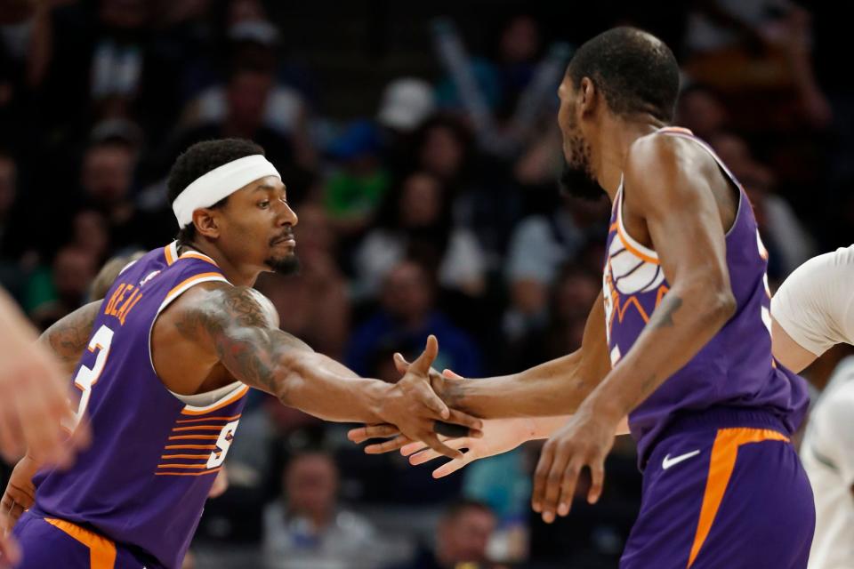 Phoenix Suns guard Bradley Beal (3) celebrates his basket against the Minnesota Timberwolves with forward Kevin Durant (35) in the fourth quarter at Target Center in Minneapolis on April 14, 2024.