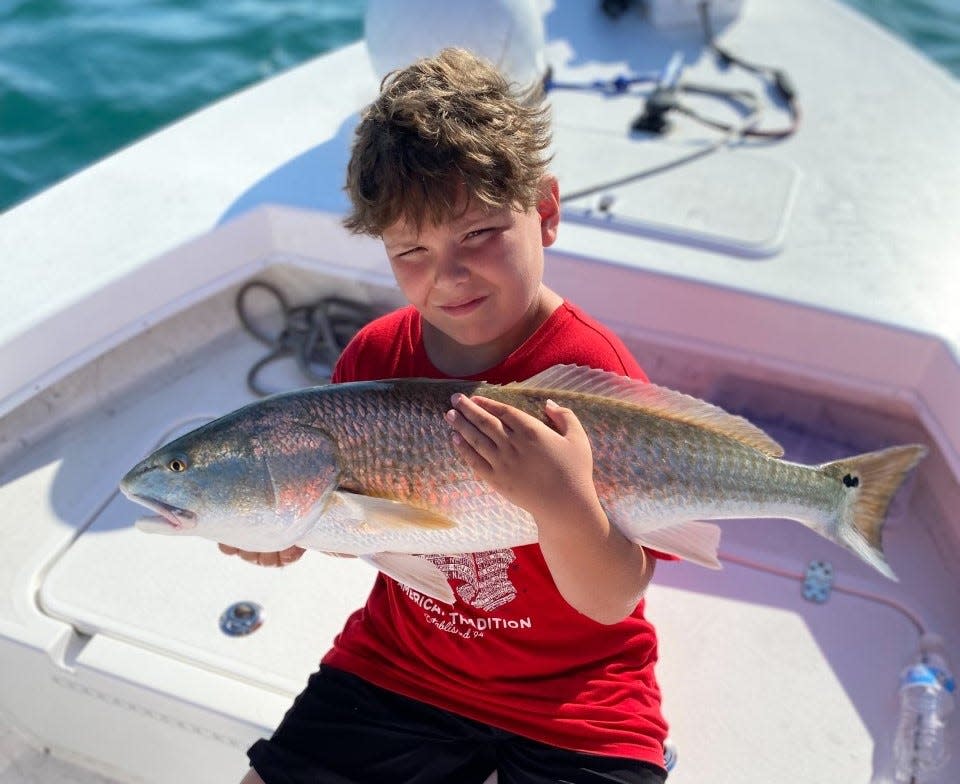 A big redfish for a little angler, with the help of Capt. Jeff Patterson aboard his Pole Dancer charter boat.