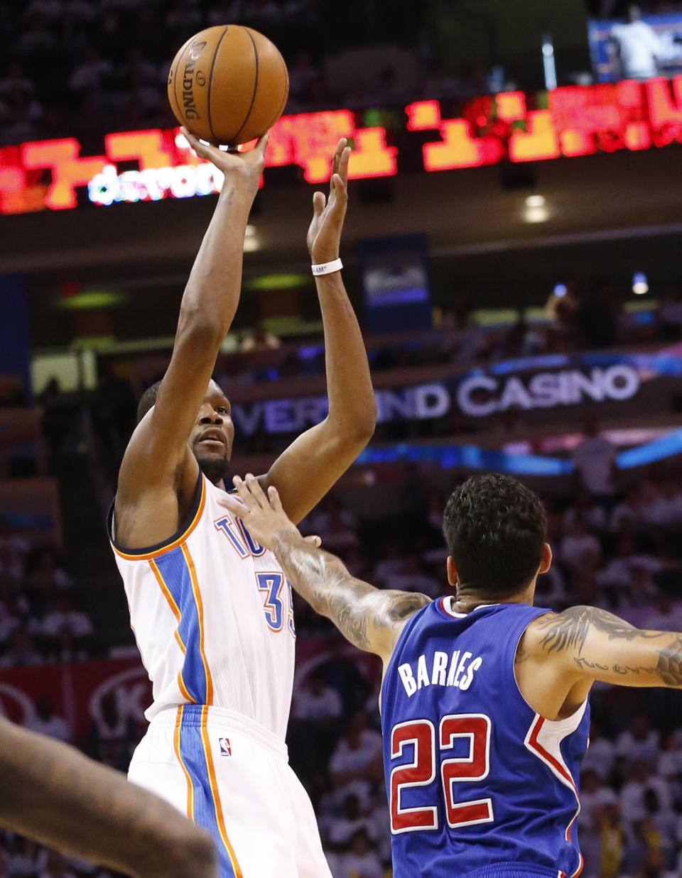 Oklahoma City Thunder forward Kevin Durant (35) shoots over Los Angeles Clippers forward Matt Barnes (22) in the second half of Game 5 of the Western Conference semifinal NBA basketball playoff series in Oklahoma City, Tuesday, May 13, 2014. Oklahoma City won 105-104. (AP Photo)