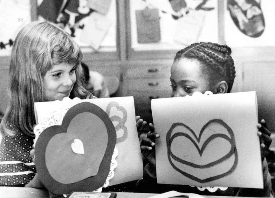 <em>Feb. 13 1988: Jennifer Wolfe, 7, and Fatima Simms, 8, at Smith Elementary School pose with Valentines to send to children in Kenya.</em> (The Denver Post/Getty Images)