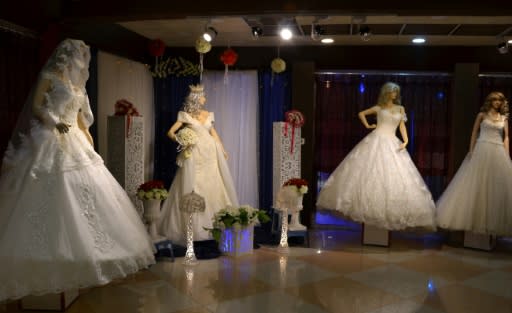 Wedding dresses are displayed in a showroom in the northern Iraqi city of Mosul on February 6, 2018