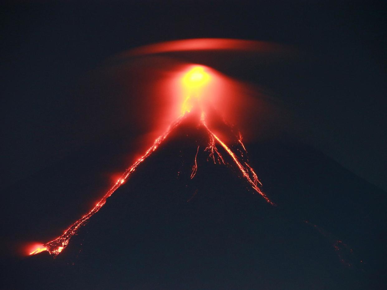 Spectacular lava 'fireworks' shooting from Mount Mayon's crater are drawing tourists to the Philippines' most active volcano: CHARISM SAYAT/AFP/Getty Images