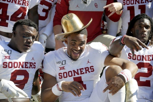 Oklahoma's Kenneth Murray (9), Jalen Hurts (1), and CeeDee Lamb (2) pose for a photo after the Red River Showdown college football game between the University of Oklahoma Sooners (OU) and the Texas Longhorns (UT) at Cotton Bowl Stadium in Dallas, Saturday, Oct. 12, 2019. Oklahoma won 34-27. [Bryan Terry/The Oklahoman]