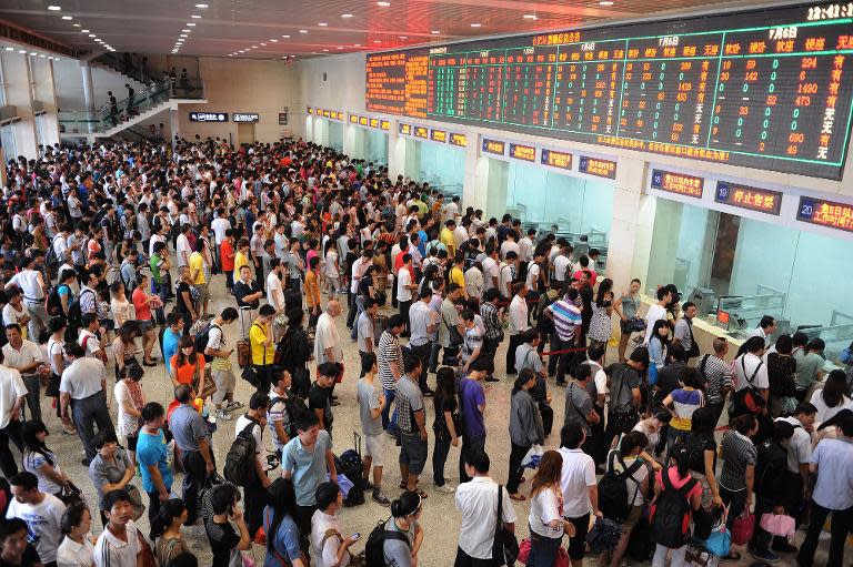 Chinese passengers queue up to buy train tickets at Hefei, Anhui province on June 27, 2012