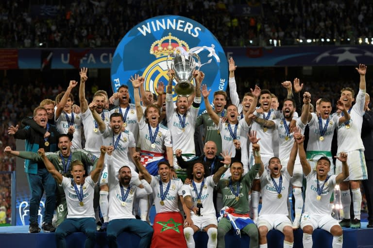 Real Madrid defender Sergio Ramos (C) lifts the trophy after winning the Champions League final against Liverpool in Kiev on May 26