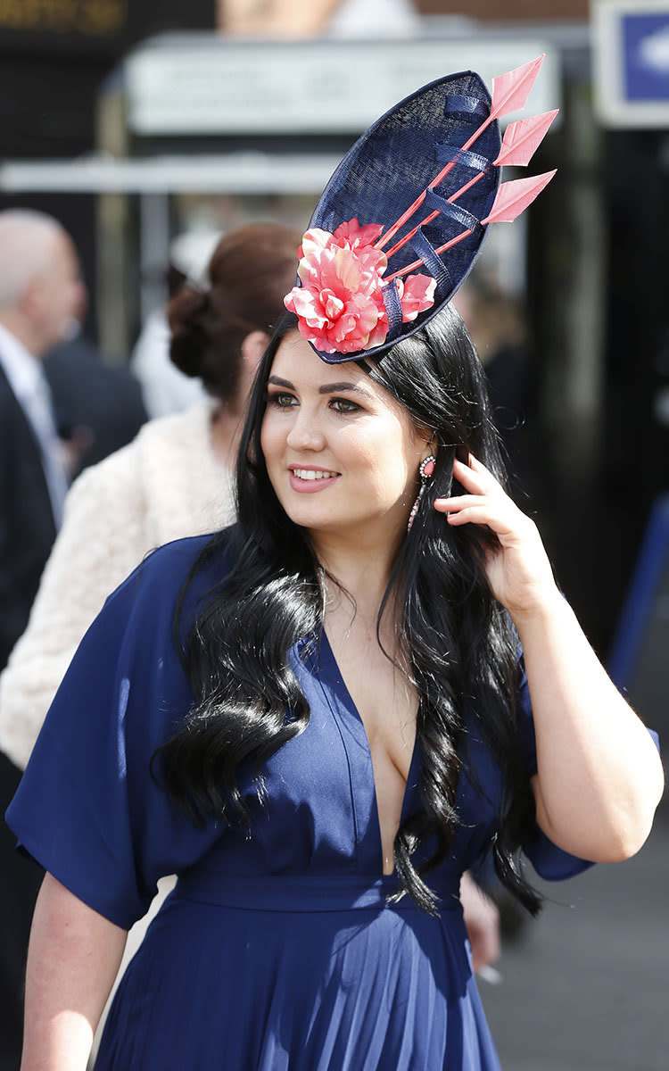 The fascinator is a Grand National staple and this woman made a statement with her arrow-adorned version.