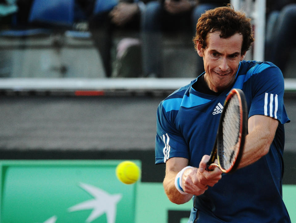 Britain's Andy Murray returns the ball to Italy's Andreas Seppi during their Davis Cup World Group quarterfinal match in Naples, Italy, Friday, April 4, 2014. (AP Photo/Salvatore Laporta)