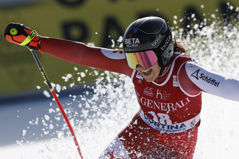 Austria's Stephanie Venier celebrates at the finish area of an alpine ski, women's World Cup downhill race, in Cortina d'Ampezzo, Italy, Friday, Jan. 26, 2024. (AP Photo/Alessandro Trovati)
