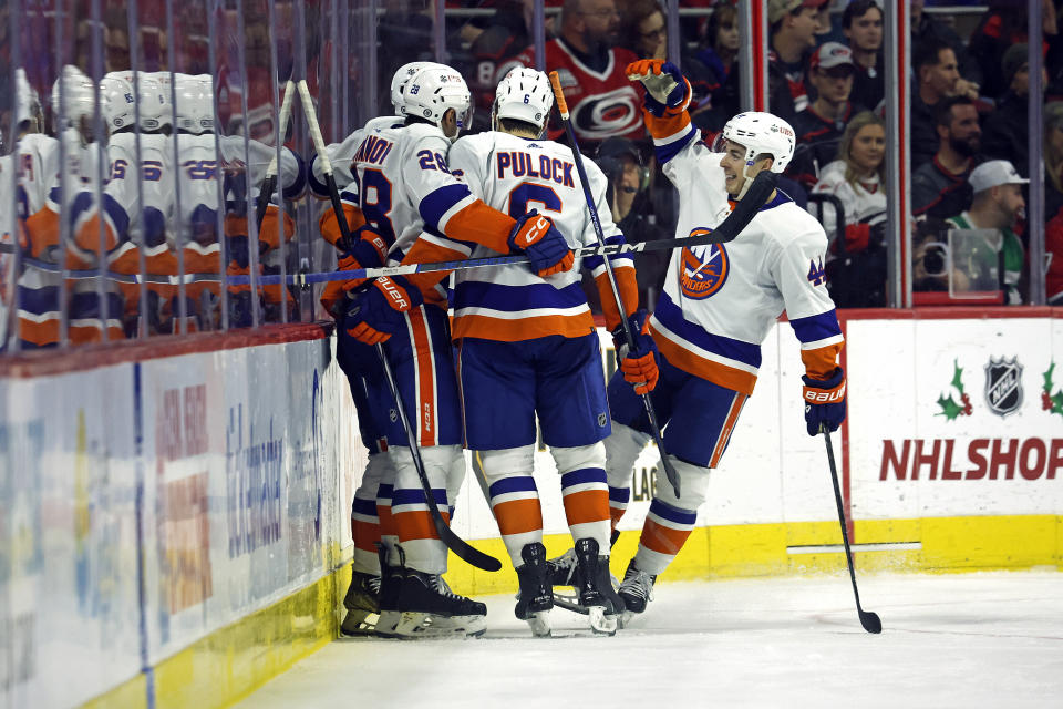 The New York Islanders celebrate a shorthanded goal by Simon Holmstrom, during the second period of an NHL hockey game against the Carolina Hurricanes in Raleigh, N.C., Thursday, Nov. 30, 2023. (AP Photo/Karl B DeBlaker)