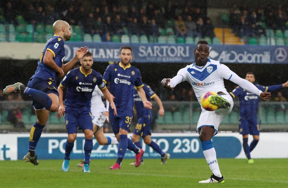 Brescia's Mario Balotelli, right, kicks the ball during the Italian Serie A soccer match between Verona and Brescia at the Bentegodi stadium in Verona, Italy, Sunday, Nov. 3, 2019. (Simone Venezia/ANSA via AP)