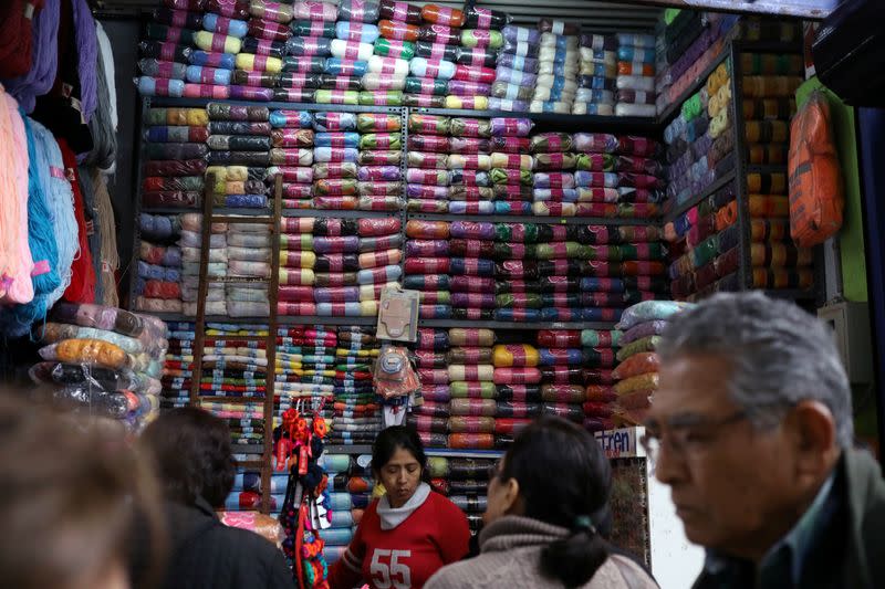 A woman sells cloth trimmings at a stand at Surco market in Lima