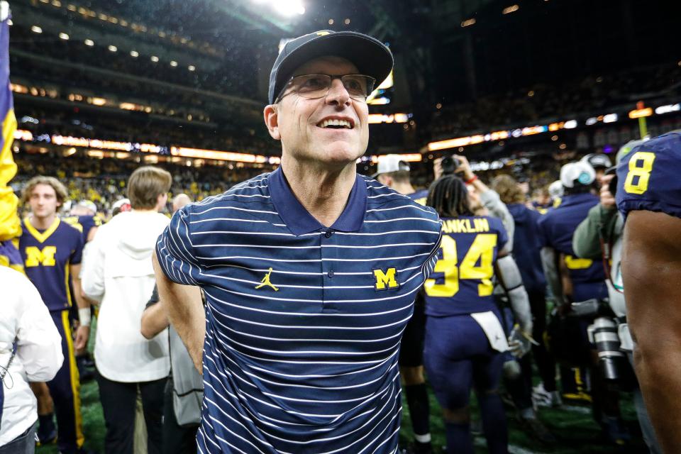 Michigan head coach Jim Harbaugh celebrates with coaches and players after winning the Big Ten championship game over Purdue at Lucas Oil Stadium in Indianapolis on Saturday, Dec. 3, 2022.