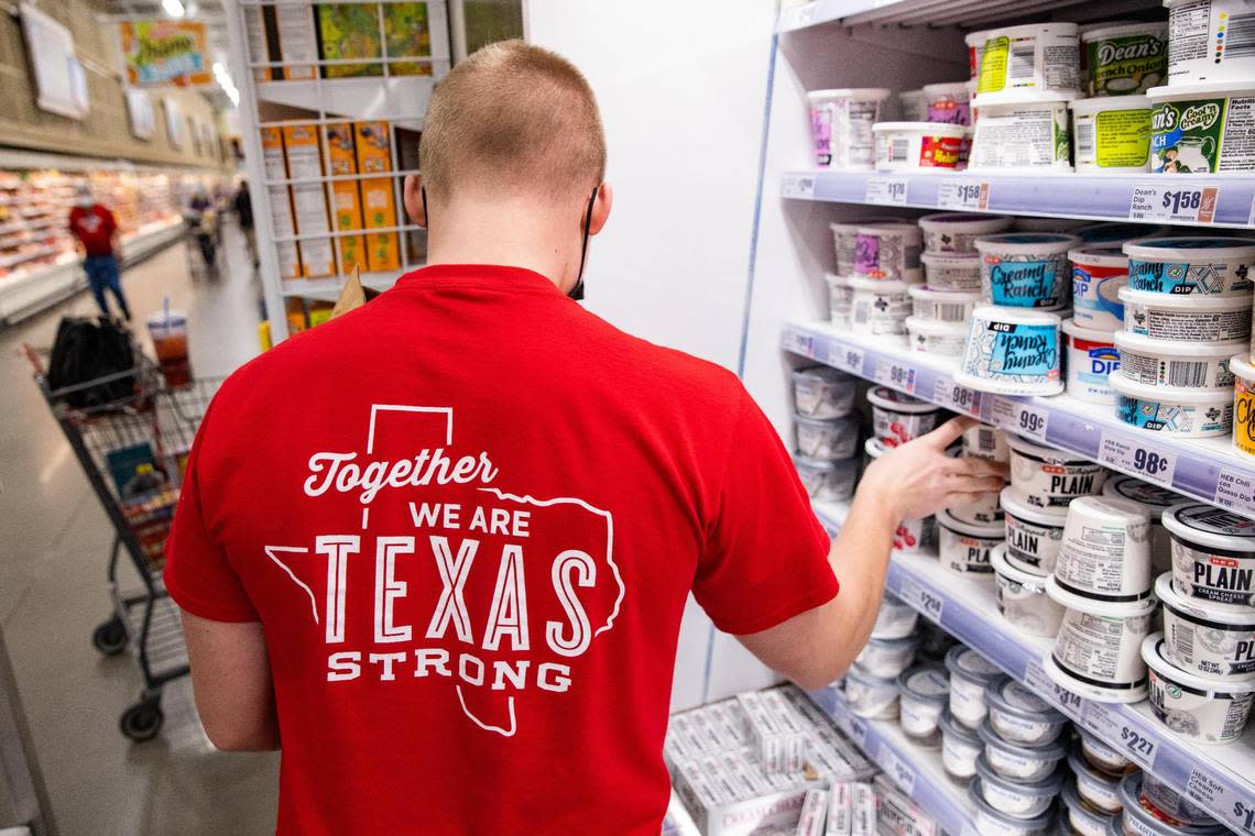 Tyler Land restocks the dairy section at the H-E-B in Hudson Oaks in March 2021.