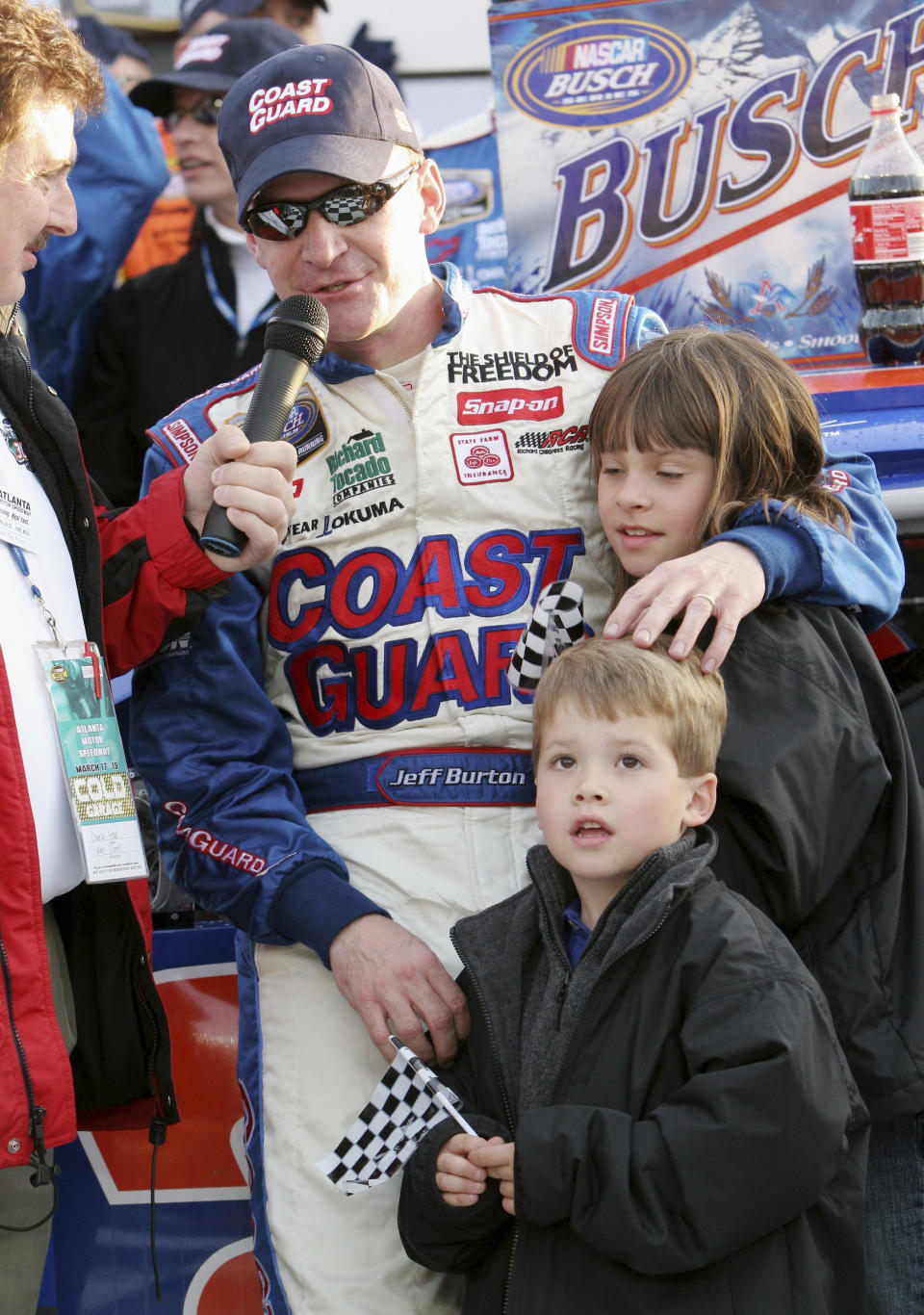 FILE - In this March 18, 2006, file photo, Jeff Burton puts his arm around his children Paige, 10, and Harrison, 5, as he is interviewed in victory lane after winning the NASCAR Busch Series' Nicorette 300 auto race at Atlanta Motor Speedway in Hampton, Ga., in this Saturday, March 18, 2006, file photo. Harrison Burton is set to make his NASCAR Cup Series debut at Talladega Superspeedway. (AP Photo/Gene Blythe, File)