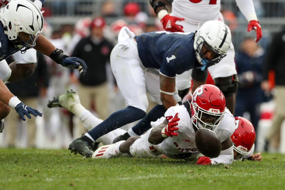Nov 20, 2021; University Park, Pennsylvania, USA; Rutgers Scarlet Knights running back Aaron Young (4) fumbles the ball during the fourth quarter against the Penn State Nittany Lions at Beaver Stadium. Penn State defeated Rutgers 28-0. Mandatory Credit: Matthew OHaren-USA TODAY Sports