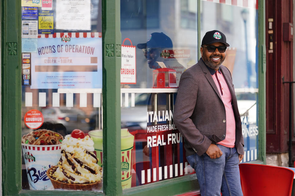 Business owner Aaron Anderson who operators multiple restaurants poses for a photograph at his Rita's Italian Ice location in Philadelphia, Friday, March 26, 2021. Restaurants and delivery companies remain uneasy partners, haggling over fees and struggling to make the service profitable for themselves and each other. Anderson thinks delivery fees are too high. But he also sees some value in delivery companies, which can help restaurants test new concepts. (AP Photo/Matt Rourke)