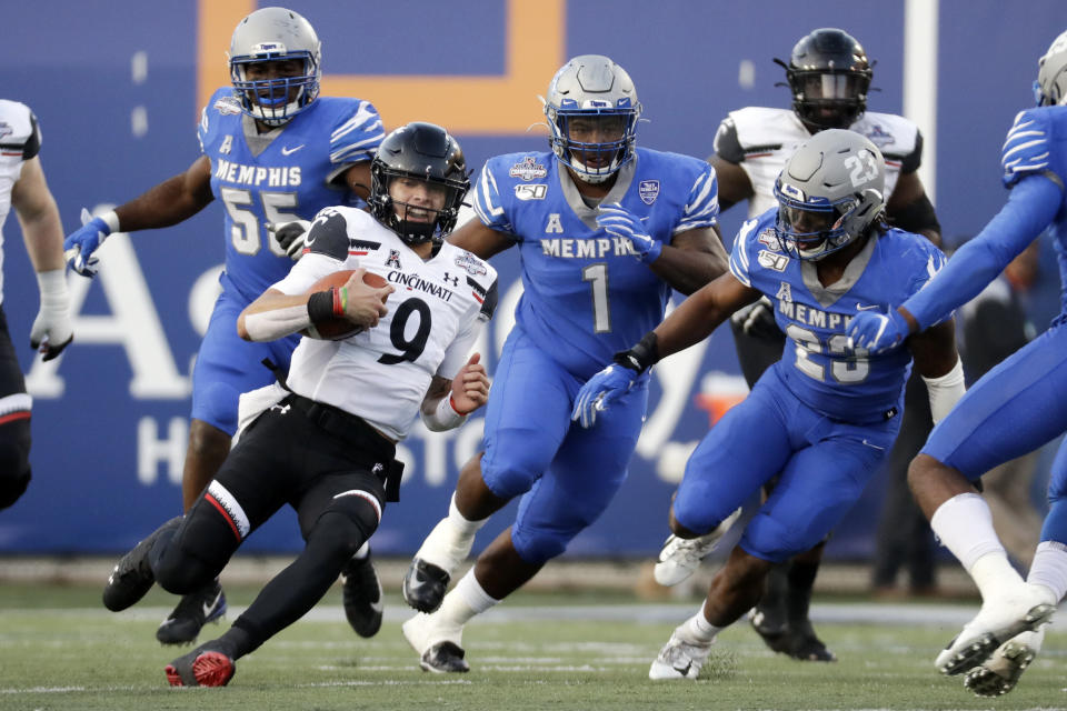 Cincinnati quarterback Desmond Ridder (9) scrambles against Memphis during the first half of an NCAA college football game for the American Athletic Conference championship Saturday, Dec. 7, 2019, in Memphis, Tenn. (AP Photo/Mark Humphrey)