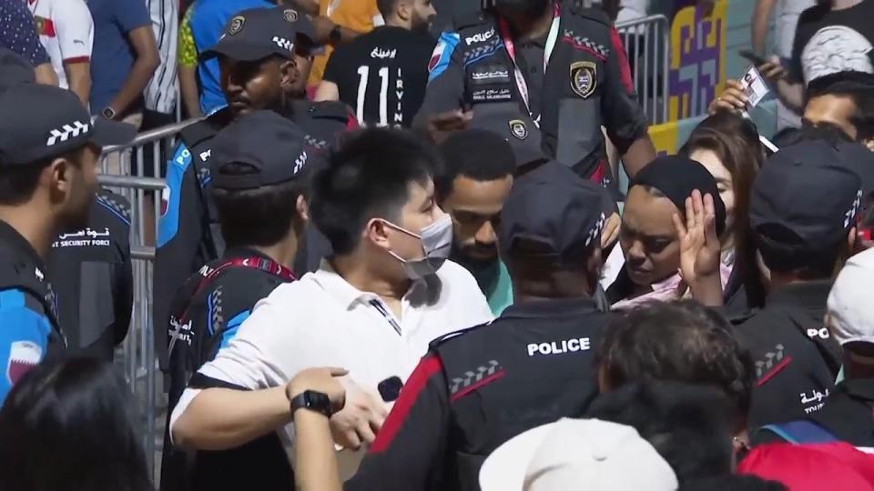 In this image from video, Qatari police try to control a crowd at a FIFA Fan Zone ahead of the World Cup in Doha, Qatar, Saturday, Nov. 19, 2022. Authorities turned away thousands of fans Saturday night from a concert celebrating the World Cup beginning the next day in Qatar, revealing the challenges ahead for Doha as it tries to manage crowds in FIFA's most-compact tournament ever. (AP Photo/Srdjan Nedeljkovic)