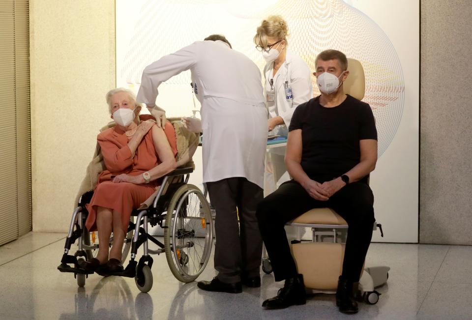 World War II veteran Emilie Repikova sits next to PM Andrej Babis as she receives the second injection nationwide with a dose of Pfizer-BioNTech COVID-19 vaccine at Military University Hospital in Prague, Czech RepublicReuters