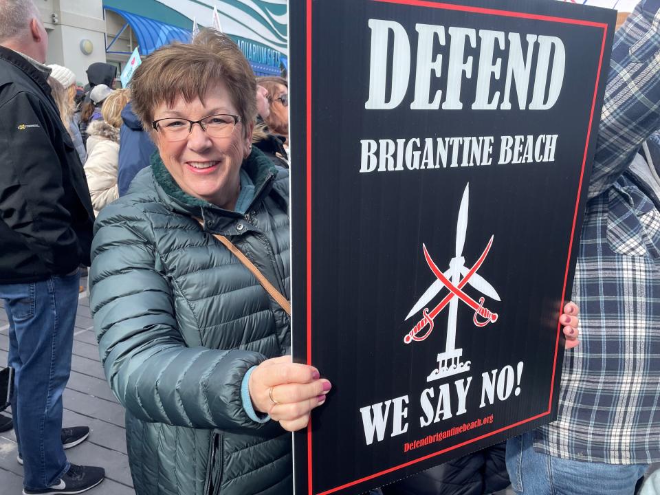 Anne Muller of Brigantine joins a protest in Point Pleasant Beach on Sunday urging federal and state officials to stop offshore wind development in response to a string of whale deaths.