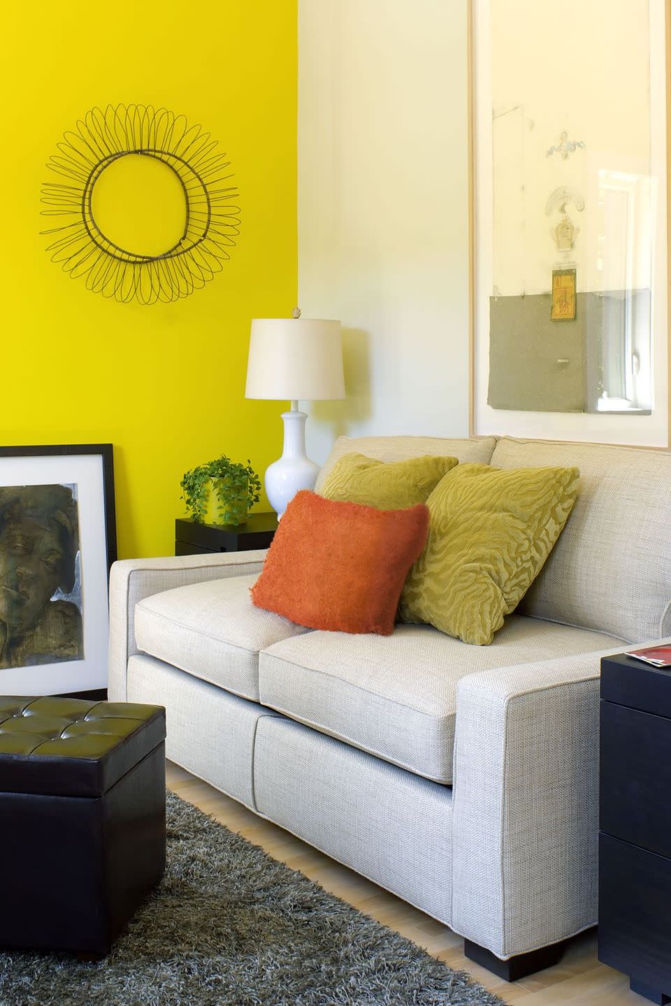 <p>Thanks to a neon yellow accent wall, this cozy living room is far from boring. </p>