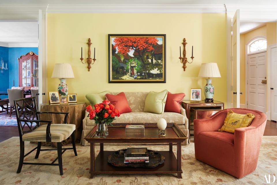 The living room and entryway are painted in Ms. Clinton’s favorite color: pale yellow (Benjamin Moore Hawthorne Yellow HC-4, to be exact). Early 19th-century Italian fruitwood sconces flank one of three paintings the Clintons purchased when in Hanoi, Vietnam. “We were on a state visit Bill made right after the beginning, again, of diplomatic relations,” says Ms. Clinton. “This one is by a young artist—just coming out of the isolation of Vietnam and opening itself to the world.” A photo from a skit the couple once performed at a White House Correspondents' Dinner sits atop a mirrored table by Amy Howard. The joke? While Ms. Clinton is busy running for Senate, her husband tries his best to stay busy—preparing his wife lunch and mowing the lawn at the White House.