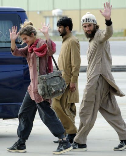 Swiss couple Daniela Widmer (L) and Olivier David Och (R) wave upon their arrival at the Qasim base in Rawalpindi. Switzerland's foreign minister said the couple escaped